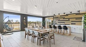Myrtle Beach apartment for rent - A modern dining room with a wooden table and chairs.