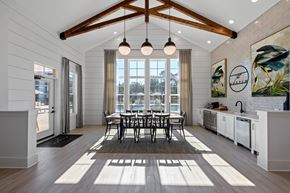 Opelika apartment for rent - A modern kitchen with a dining table and chairs in the middle of the room.