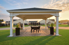 Greenville townhouse for rent - A white gazebo with a table and chairs is set up in a grassy area.