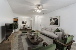 Fayetteville apartment for rent - A living room with a couch, chairs, and a television.