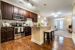 Cary apartment for rent - A kitchen with dark brown cabinets and a white island.