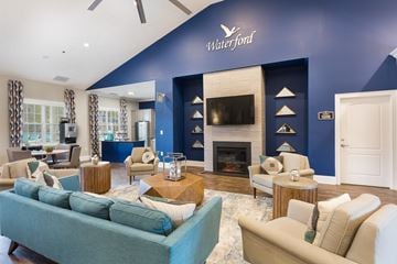 Spring Lake apartment for rent - A living room with a blue couch and a fireplace.