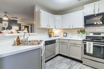 Murfreesboro apartment for rent - A kitchen with white cabinets and a stainless steel sink.