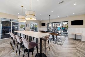 Kernersville apartment for rent - a communal dining room with tables and chairs and a pool table