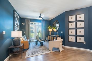 Mooresville apartment for rent - A living room with a white sofa and a grey rug.