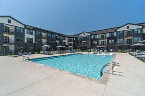 Mooresville apartment for rent - A large swimming pool in front of apartment buildings at Evolve Lake Norman apartments in Mooresville, NC
