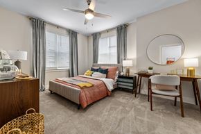 Wake Forest apartment for rent - A bedroom with a bed, desk, and chair.