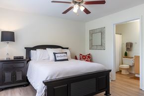 Clarksville apartment for rent - a bedroom with a large bed and a ceiling fan