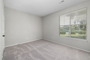Greensboro apartment for rent - an empty bedroom with a large window and carpeting