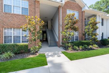 Durham apartment for rent - A brick building with a green lawn in front.