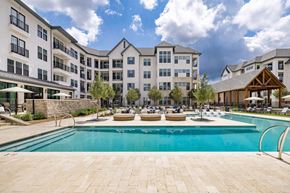 Birmingham apartment for rent - a swimming pool with an apartment building in the background
