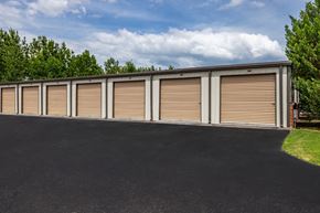 Clanton apartment for rent - a row of garage doors on the side of a building