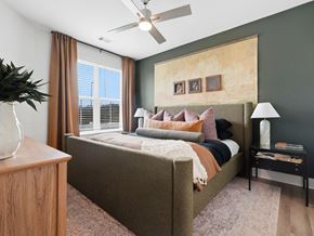 Hixson townhouse for rent - A bedroom with a bed, nightstand, and a ceiling fan.