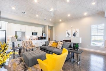 Lake Charles apartment for rent - a living room with yellow chairs and a gray couch