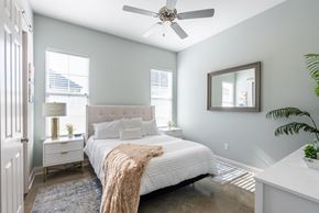 Lake Charles apartment for rent - a bedroom with a large bed and a ceiling fan