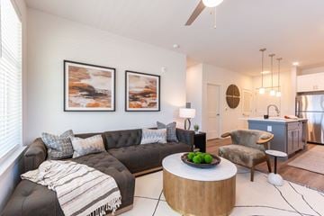 Greensboro apartment for rent - A modern living room with a black couch and a coffee table.