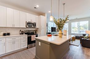 Greensboro apartment for rent - A modern kitchen with white cabinets and a large island.