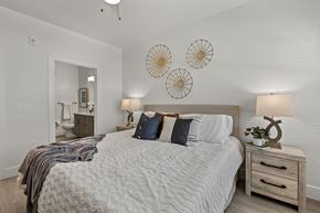 Fort Myers apartment for rent - a bedroom with a bed and two clocks on the wall