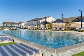 San Antonio apartment for rent - A large swimming pool with a blue tiled edge and a striped concrete ledge.