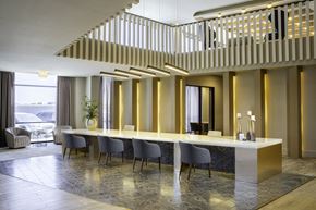 Houston apartment for rent - A reception area with a long table and chairs at 27Seventy Lower Heights apartments in Houston, TX.