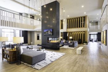 Clubroom with tvs, a fireplace, kitchen, & coffee bar