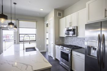 Granite or quartz countertops with tile backsplash in kitchens & bathrooms
