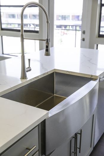 Custom kitchen cabinetry with spacious, under-mount, single-bowl, farmhouse kitchen sinks