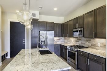 Custom kitchen cabinetry with spacious, under-mount, single-bowl, farmhouse kitchen sinks