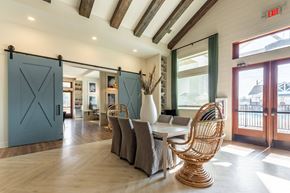 Leland apartment for rent - a dining room with a table and chairs and sliding barn doors