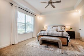 Hixson apartment for rent - A bedroom with a large bed and a ceiling fan.