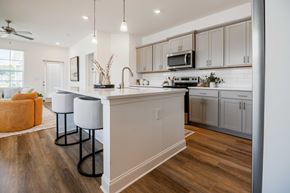 Hixson apartment for rent - A kitchen with a white counter and bar stools.