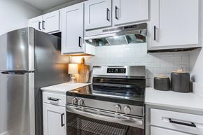 Savannah apartment for rent - A modern kitchen with a stainless steel refrigerator, oven, and other appliances.
