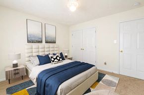 Fayetteville apartment for rent - a bedroom with a bed and two closet doors