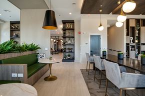 Raleigh apartment for rent - a communal area with a bar and chairs and a kitchen and dining room