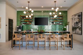 Raleigh apartment for rent - a dining room with a long table and chairs and a television