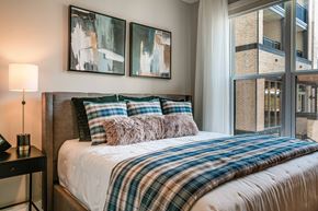 Raleigh apartment for rent - a bedroom with a bed and a large window