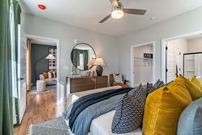 Charlotte townhouse for rent - A bedroom with a bed, a dresser, and a mirror.
