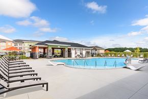 Ooltewah apartment for rent - A swimming pool area with sun loungers and a building in the background