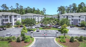 Myrtle Beach apartment for rent - A parking lot in front of apartment buildings.