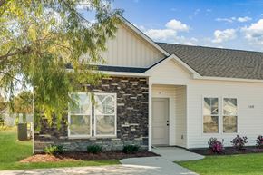 Greenville townhouse for rent - A house with a white exterior and a stone pillar on the front.