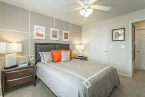 Chattanooga apartment for rent - Spacious bedroom with plush carpeting and ceiling fan with lighting
