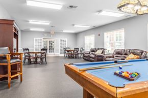 Clarksville apartment for rent - a common room with a pool table and chairs and a dining area