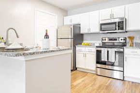 Clarksville apartment for rent - a kitchen with stainless steel appliances and white cabinets