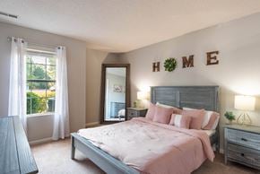 Charlotte apartment for rent - a bedroom with a large bed and a large window