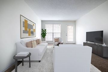 Raleigh apartment for rent - A living room with a white couch, a white coffee table, and a large painting on the wall.