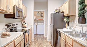 Rock Hill apartment for rent - A kitchen with wooden cabinets and a white countertop.