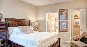 Rock Hill apartment for rent - A bedroom with a large bed and a painting on the wall.