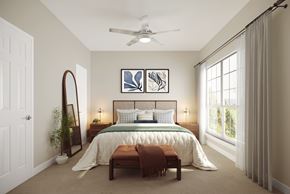 Durham apartment for rent - A bedroom with a large bed, a mirror, and a ceiling fan.