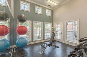 Greensboro apartment for rent - Indoor Gym with a Weight Bench and Row of Windows to See Out.