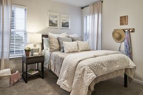 Murfreesboro apartment for rent - a bedroom with a large bed and two windows